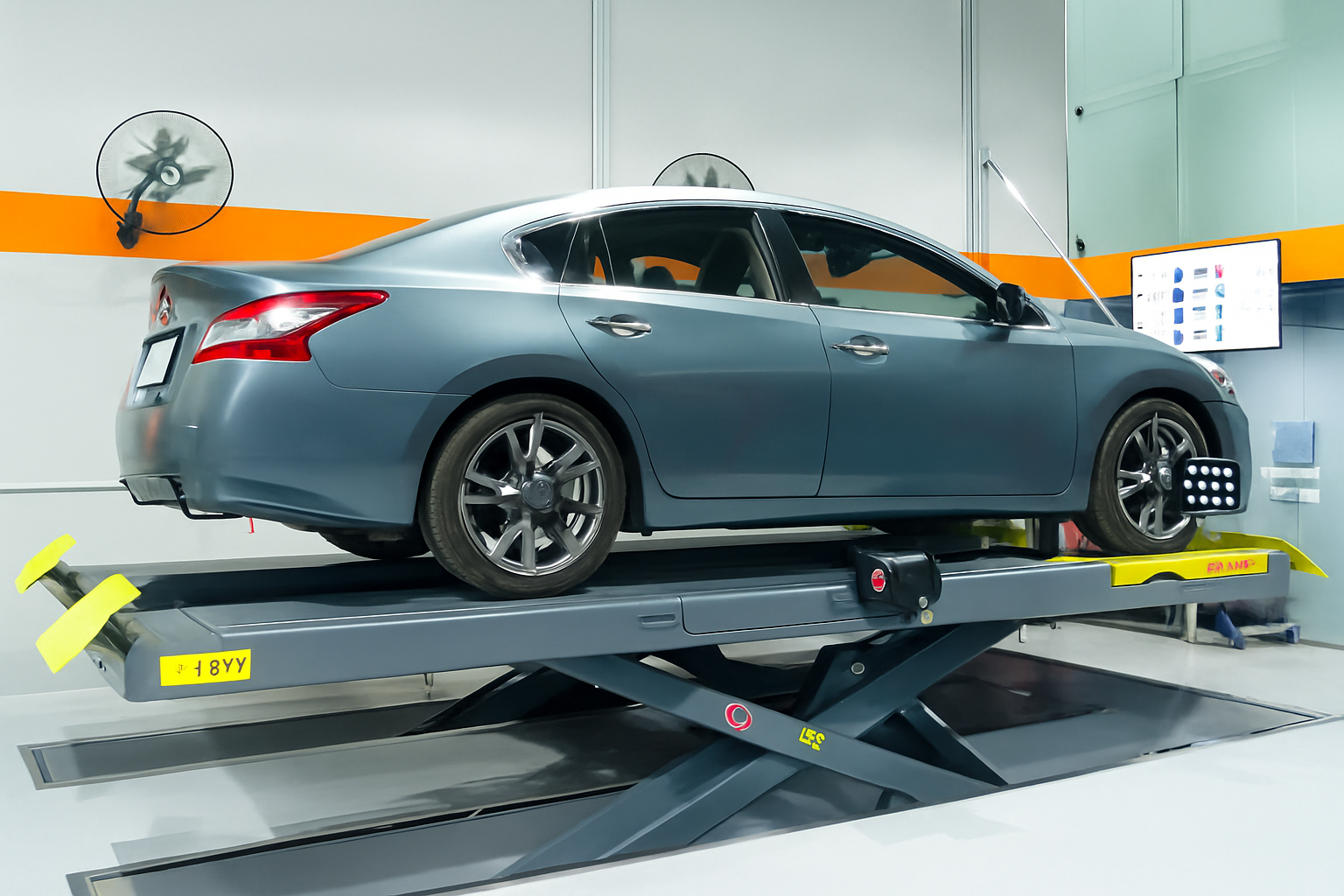 Technician performing wheel alignment in Dubai